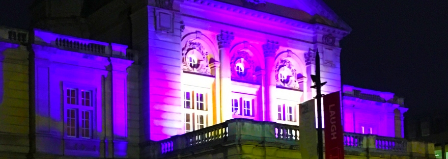 Cheltenham Town Hall lit up in purple light during Light Up Cheltenham